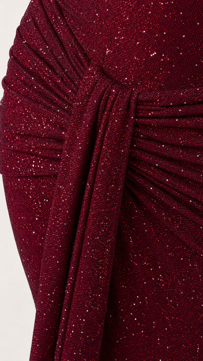 Close-up of ruched draping on burgundy glitter evening dress