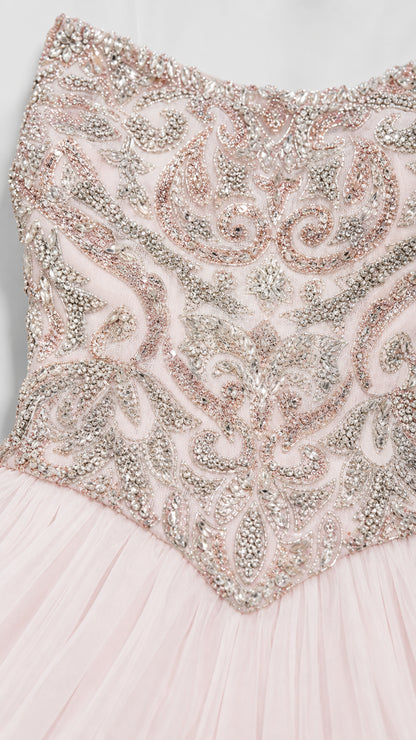 Close-up of intricate silver and pink beadwork on the bodice
