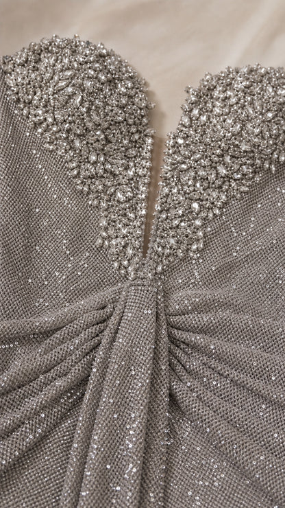 Close-up detail of embellished sweetheart neckline and textured fabric