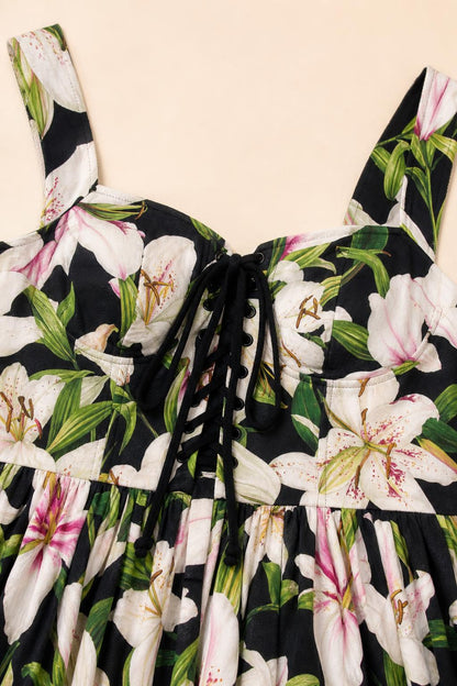 Close-up detail of lace-up square neckline and floral print fabric