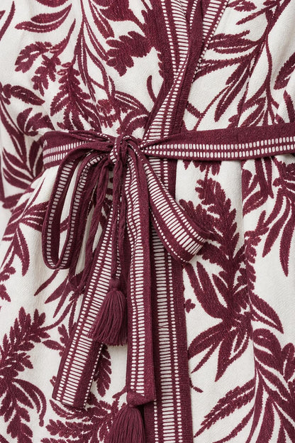 Close up of self-tie belt and fabric detail on jumpsuit