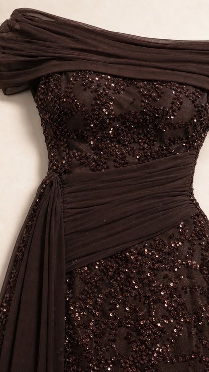 Close-up detail of draped off-shoulder neckline and sequin texture