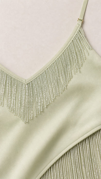 Close-up of mint beaded fringe neckline and pleated detail