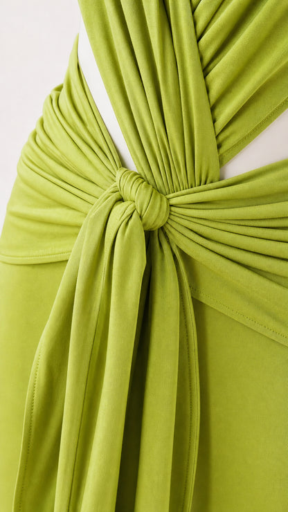 Close-up detail of the front tie knot and draped fabric on lime green jumpsuit