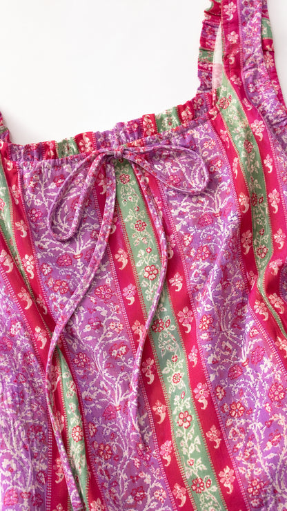 Close-up detail of square neck and front tie on pink maxi dress