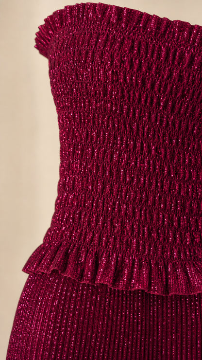 Close-up of the burgundy pleated textured fabric and ruched lower bodice
