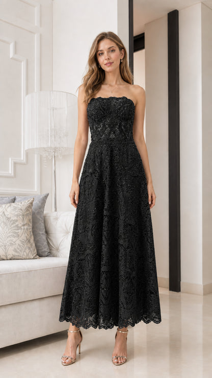 Front view of model wearing black strapless lace midi dress