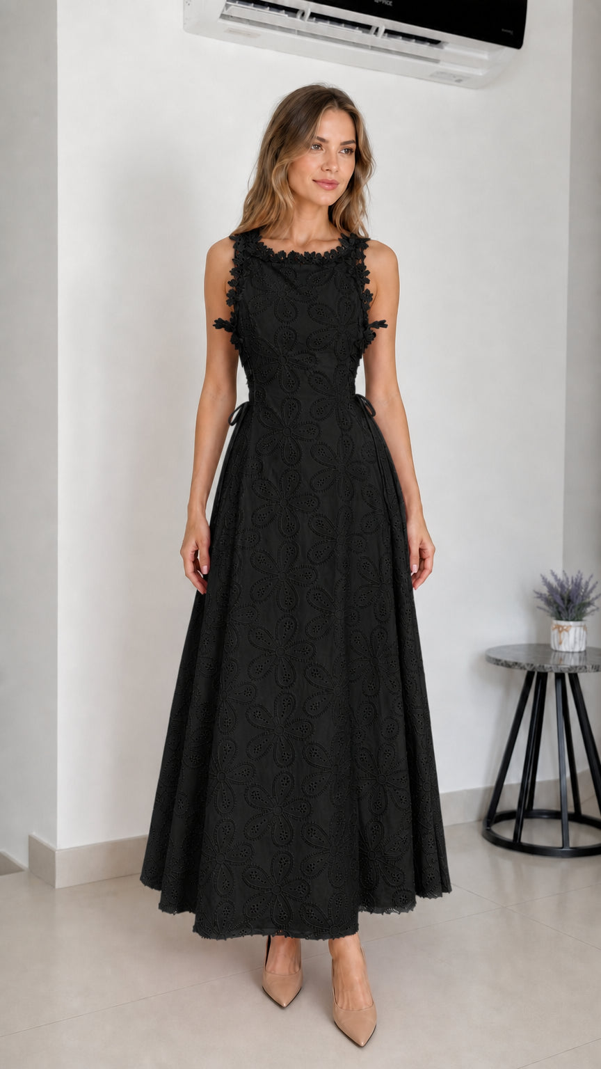 Model wearing black embroidered eyelet maxi dress