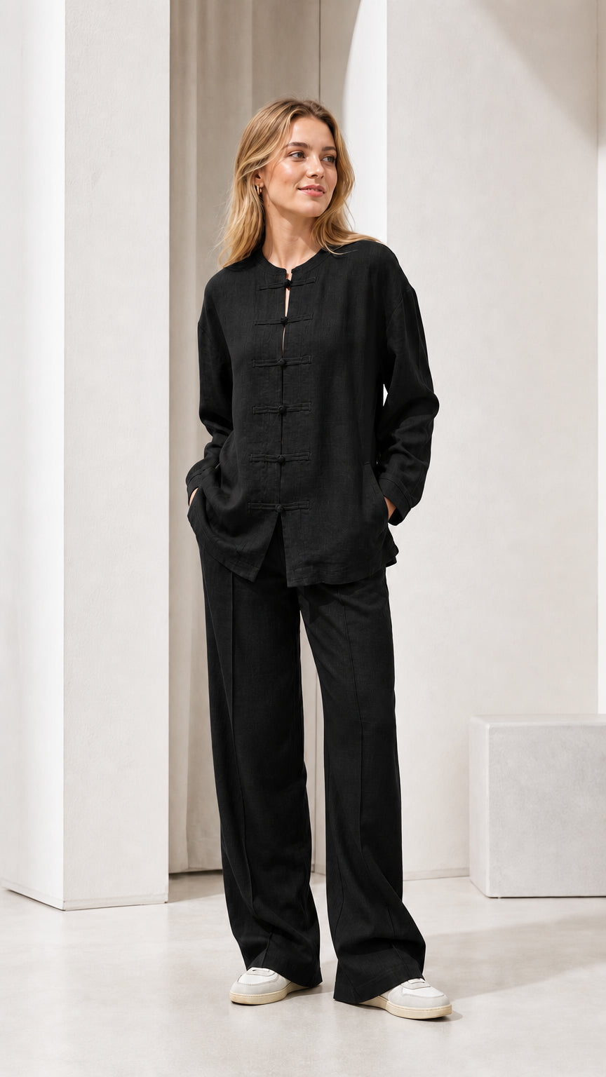 Model wearing black linen-blend long sleeve top and wide leg pants set