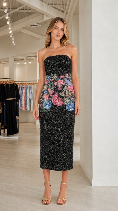 Model wearing black floral sequin strapless midi dress