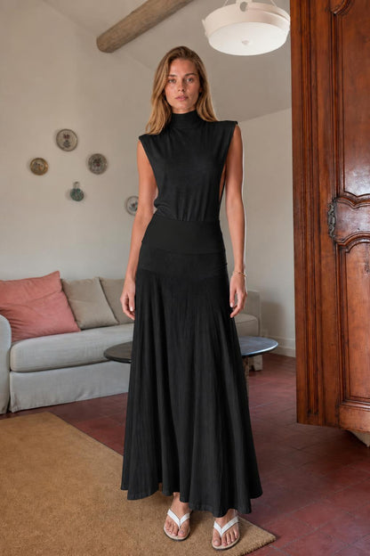 Model wearing black sleeveless mock neck knit maxi dress