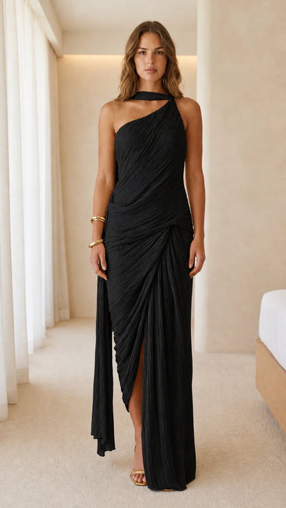 Front view of woman wearing black one-shoulder pleated maxi dress