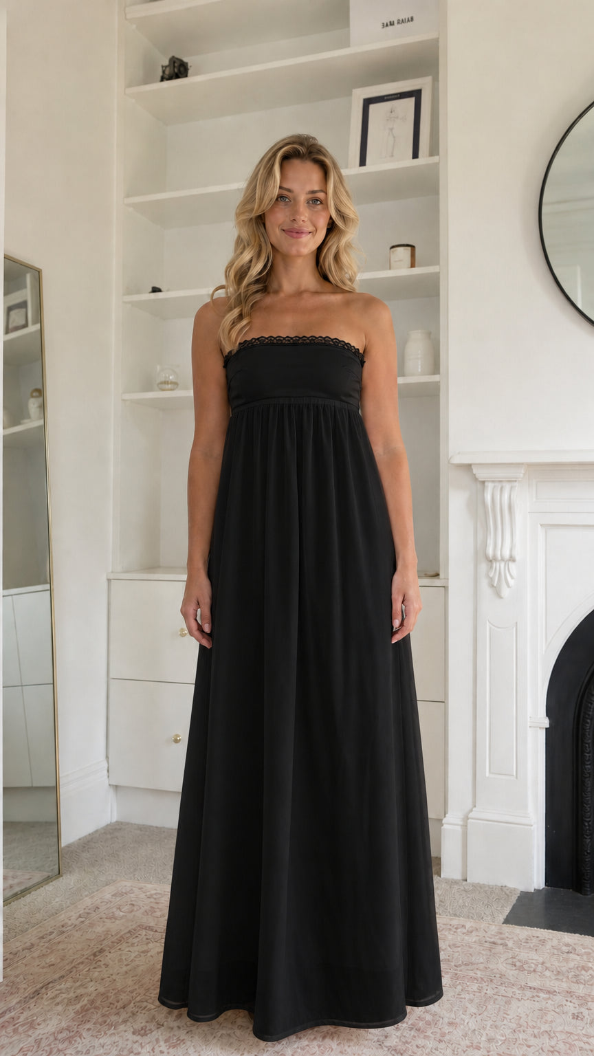 Woman wearing black strapless maxi dress