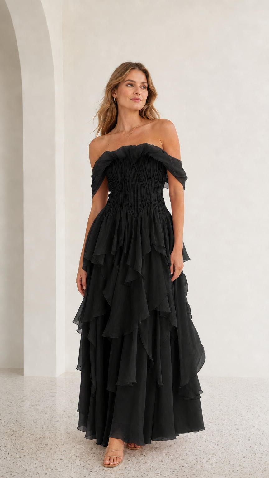 Front view of black off-shoulder tiered maxi dress
