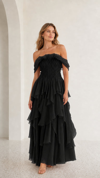 Front view of black off-shoulder tiered maxi dress