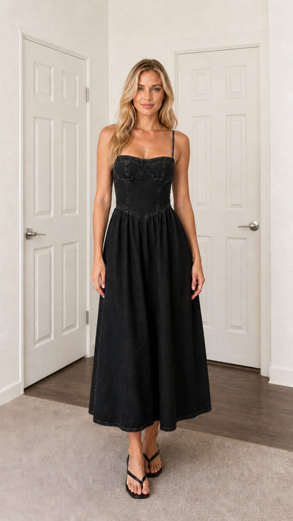 Front view of woman wearing black denim midi dress