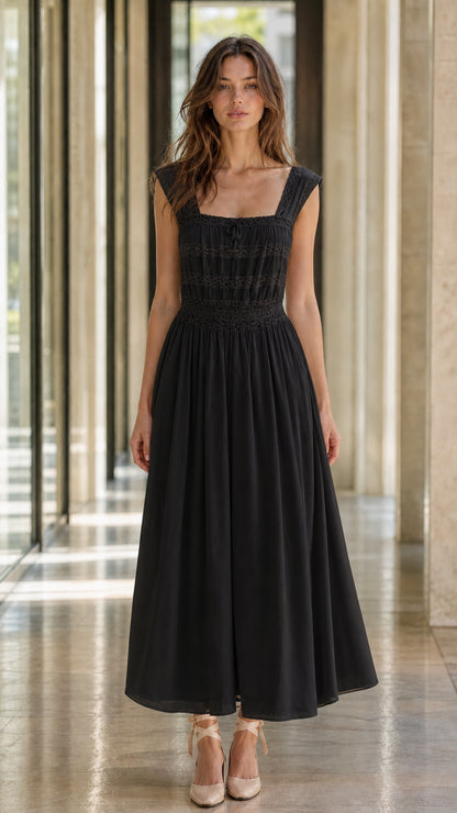 Front view of model wearing black midi dress