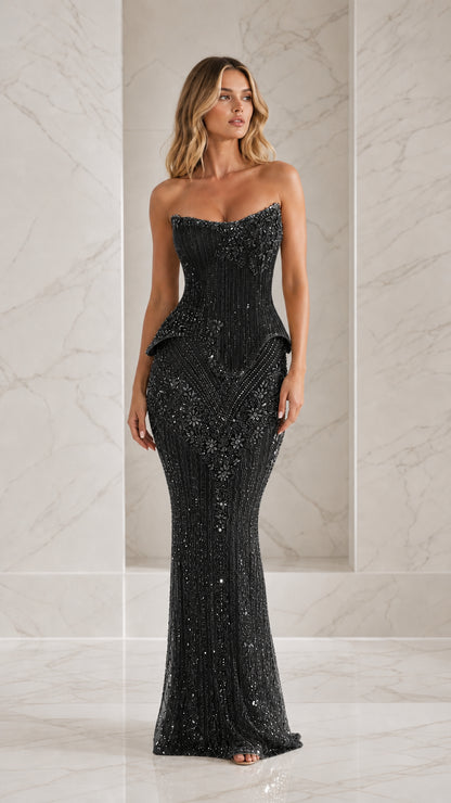 Front view of model wearing black beaded strapless evening gown