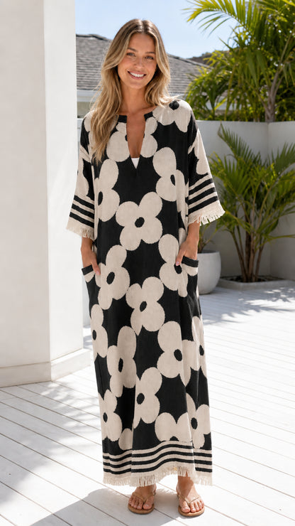 Woman wearing black and white floral jacquard maxi dress