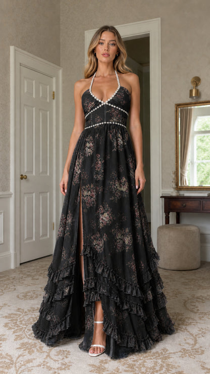 Model wearing black floral print pearl-trimmed halter maxi dress