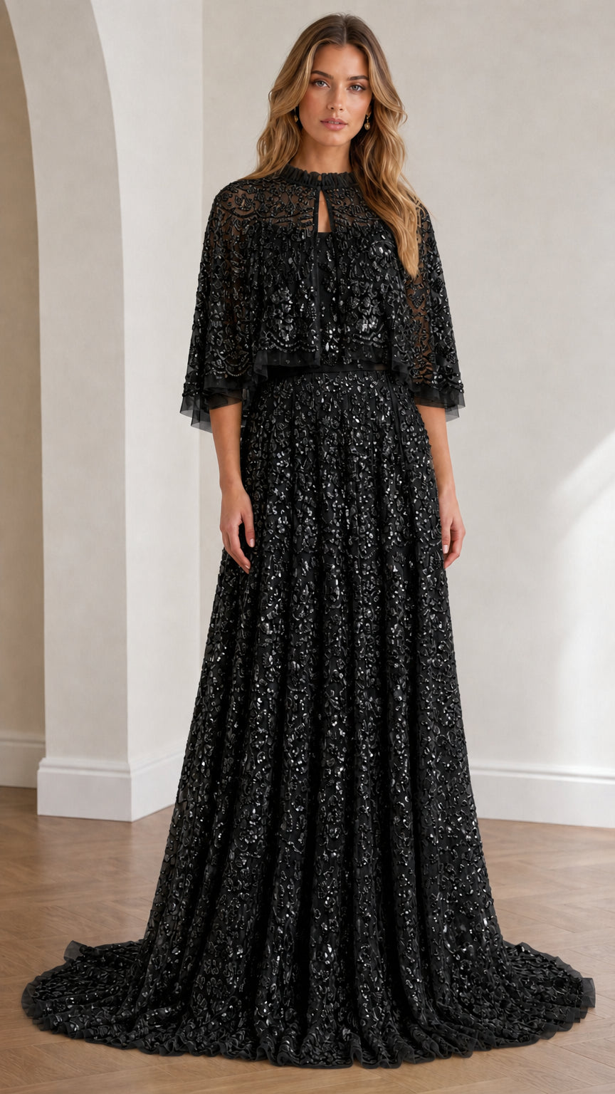 Full view of black sequin lace capelet evening gown