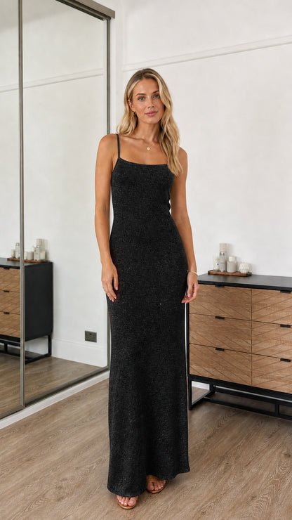 Model wearing black sequin spaghetti strap maxi dress