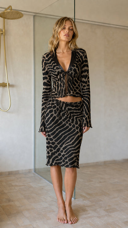 Front view of black animal print crop top and midi skirt set