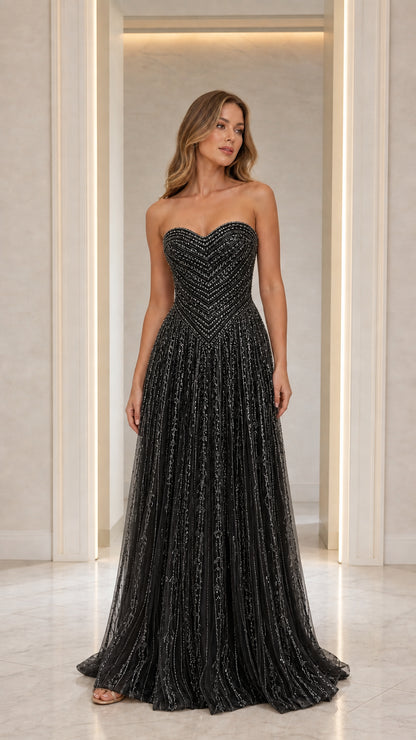 Front view of model in Black strapless beaded gown