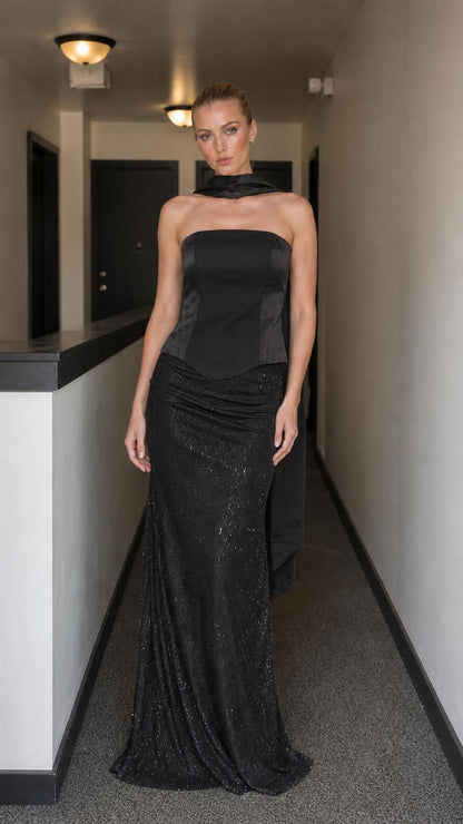 Model wearing black evening gown set with corset bodice