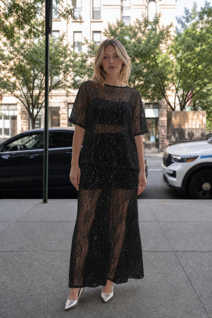 Woman wearing black sheer sequin lace two-piece set