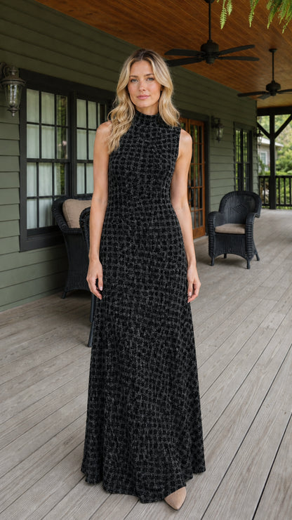 Front view of woman wearing black textured sleeveless maxi dress
