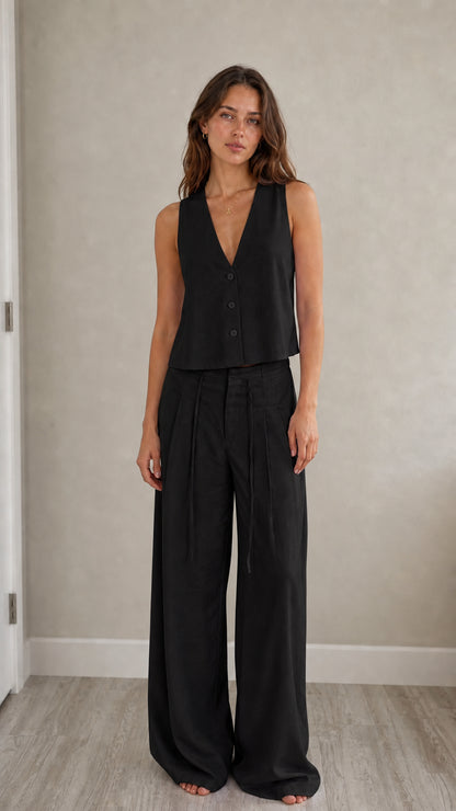Full-length view of model in black two-piece vest and pants set