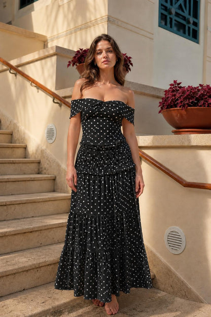 Model wearing black polka dot off-the-shoulder maxi dress