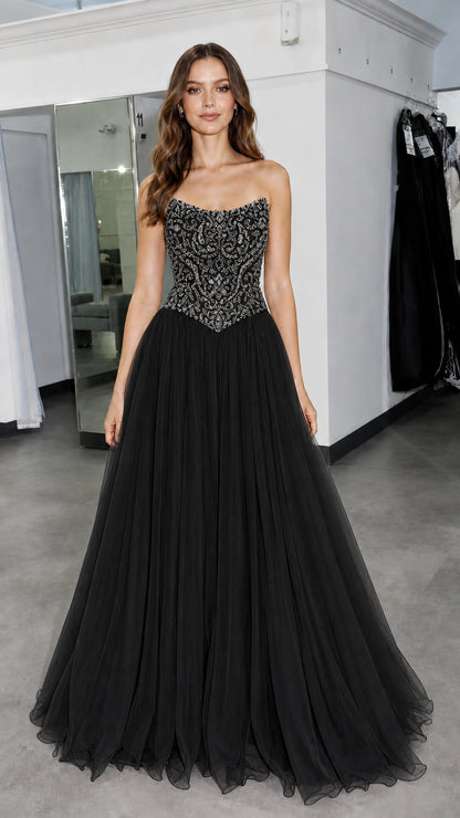 Front view of model wearing black beaded evening gown
