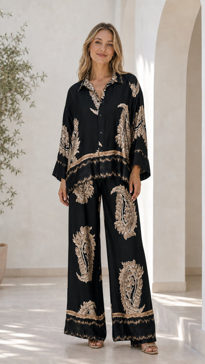 Front view of model in black satin paisley print lounge set