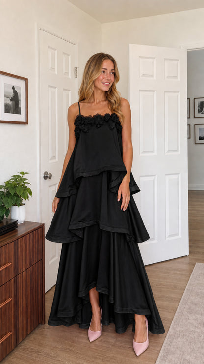 Front view of model wearing black tiered ruffle cami maxi dress