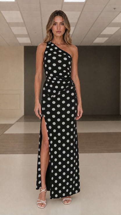 Front view of black and white polka dot one shoulder maxi dress