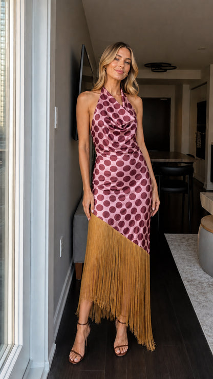 Woman wearing pink and tan polka dot fringe maxi dress
