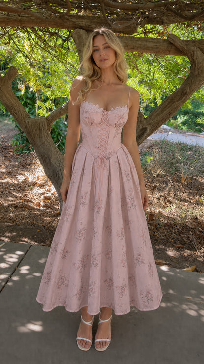 Woman wearing pink floral corset midi dress