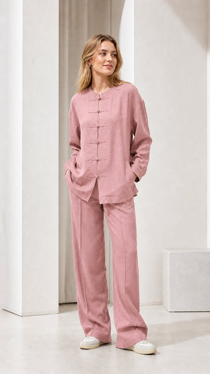 Model wearing pink linen-blend long sleeve top and wide leg pants set