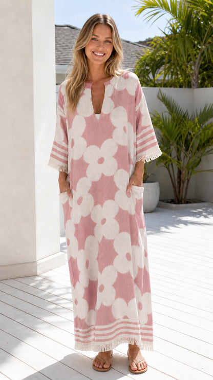 Woman wearing pink and white floral jacquard maxi dress