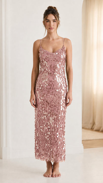 Front view of woman wearing pink sequin midi dress