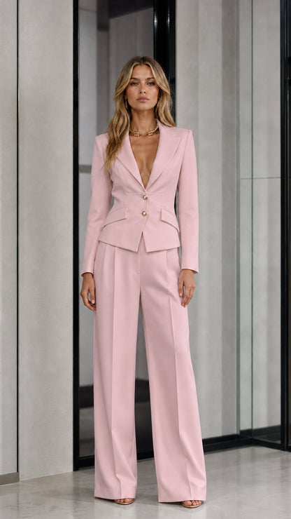 Front view of woman wearing soft pink tailored blazer and wide leg pants suit
