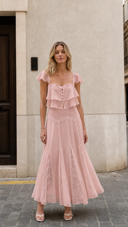 Front view of woman wearing pink ruffled two-piece maxi set