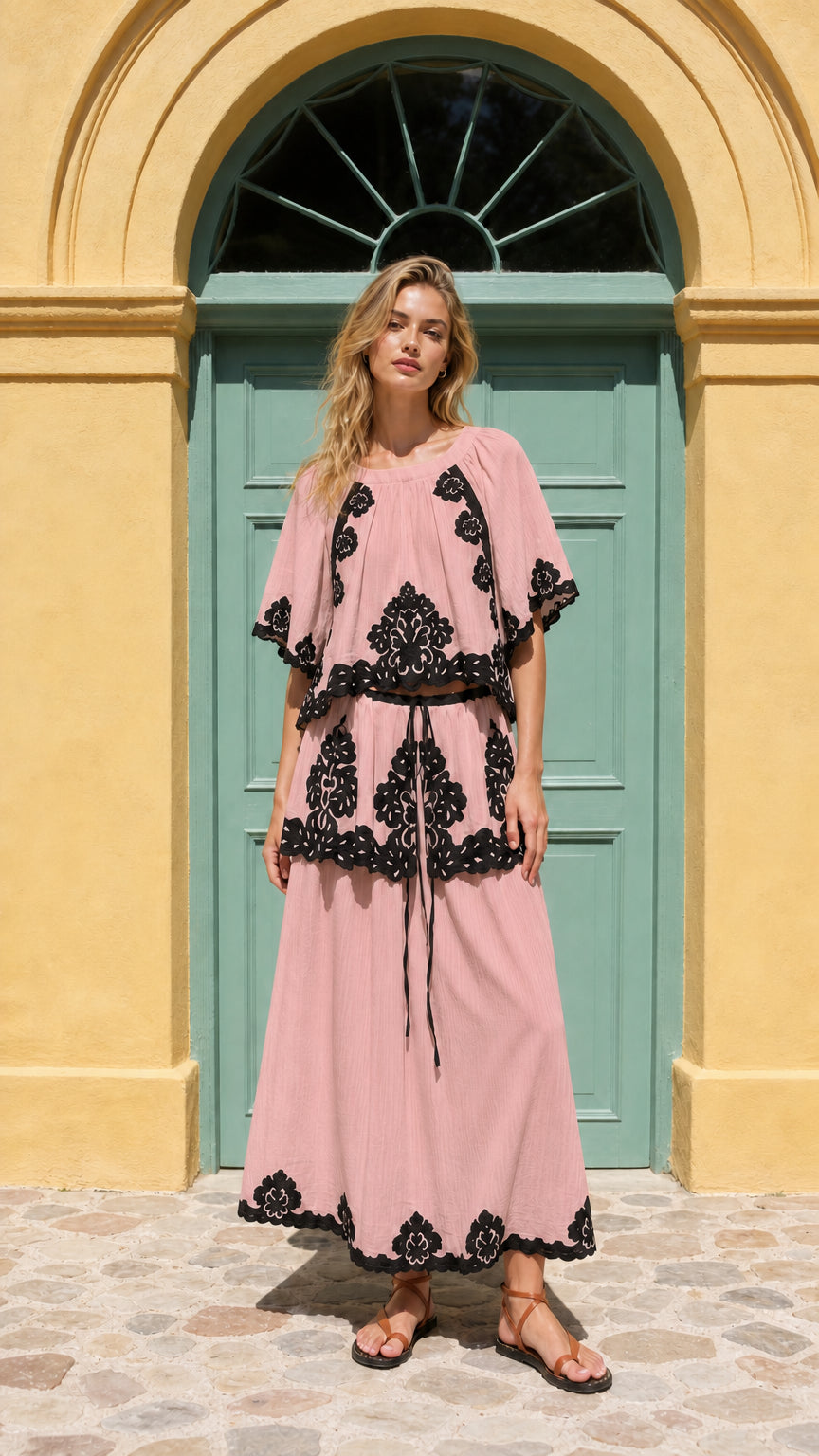 Front view of model wearing pink two-piece embroidered maxi set