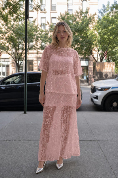 Woman wearing pink sheer sequin lace two-piece set