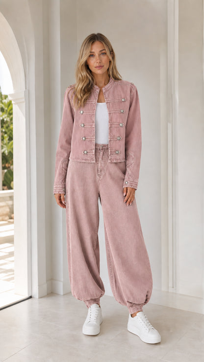 Front full view of woman wearing dusty pink utility jacket and matching pants