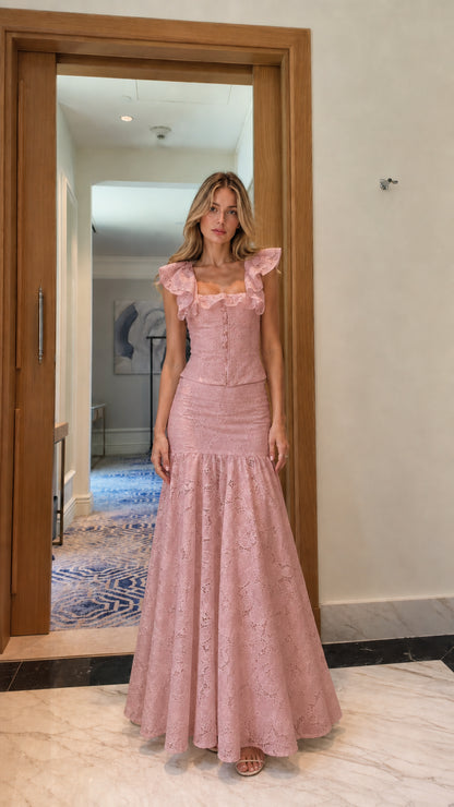 Model wearing pink lace crop top and mermaid maxi skirt set