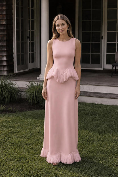 Front view of model wearing pink fringed peplum maxi dress