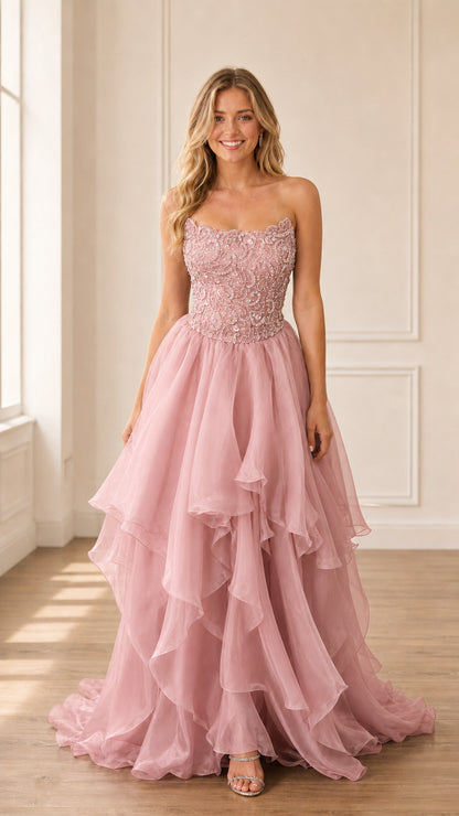 Model wearing blush pink strapless beaded tiered gown